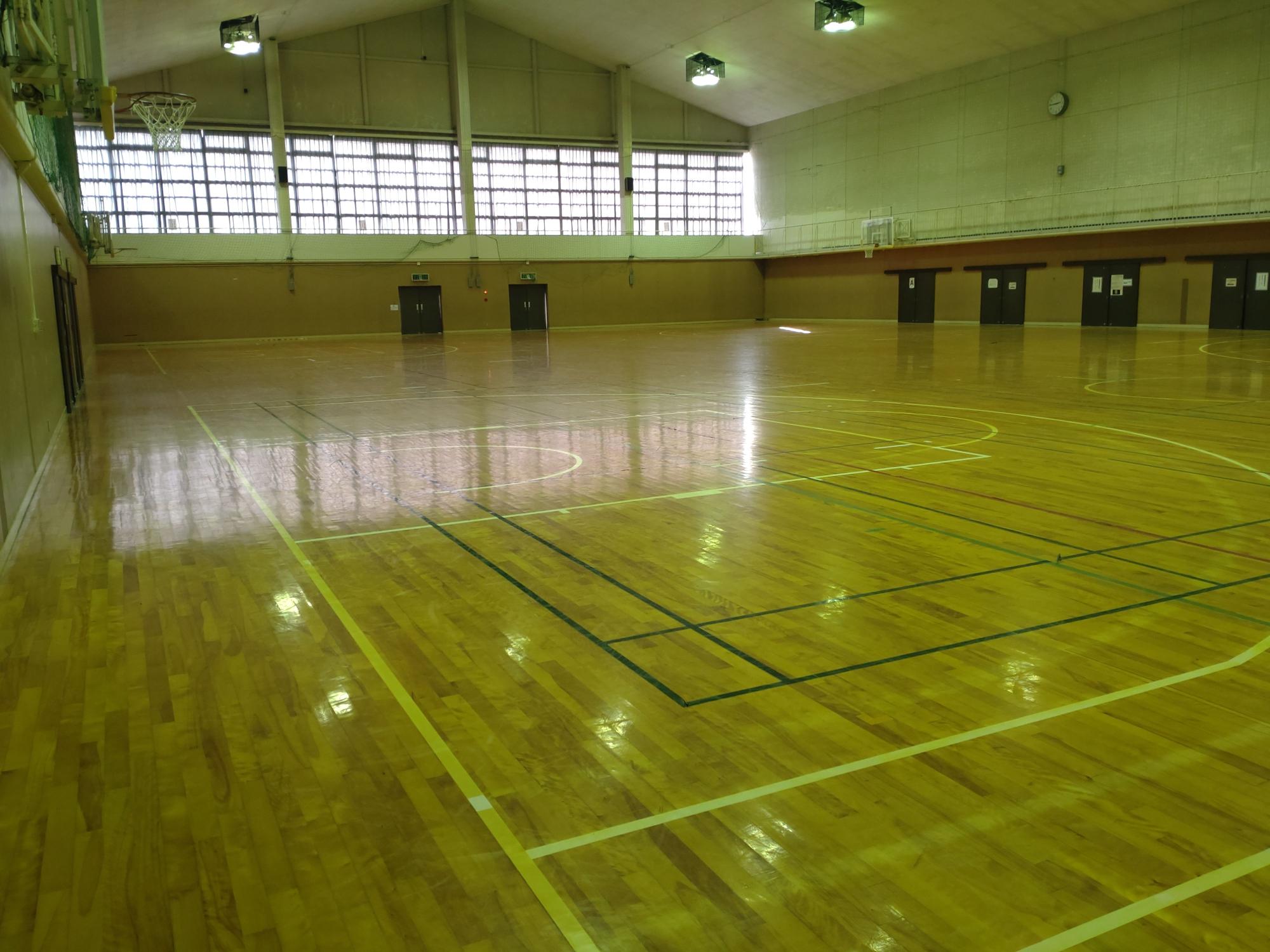 バスケットボールコートが2面並ぶ広い1階アリーナの写真