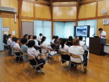 木造の教室でモニター画面を使って発表をしている様子の写真