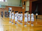 体育館でバスケットボール部の選手たちが整列している写真