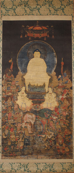 大きな白い釈迦の像を中心に小さな像が周りに隙間なく描かれた掛け軸の写真