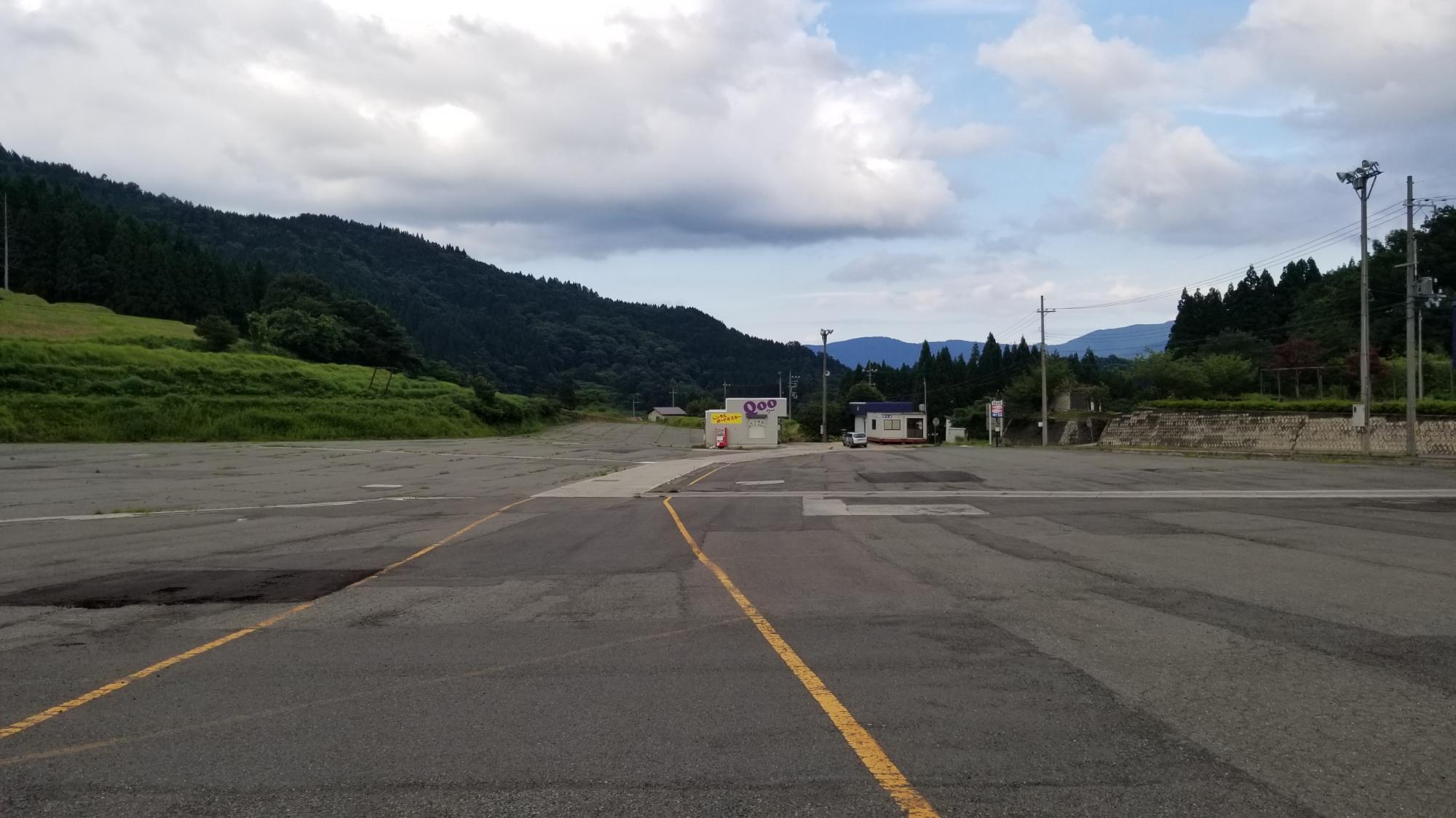 黄色い線が引かれたアスファルトの広場の写真