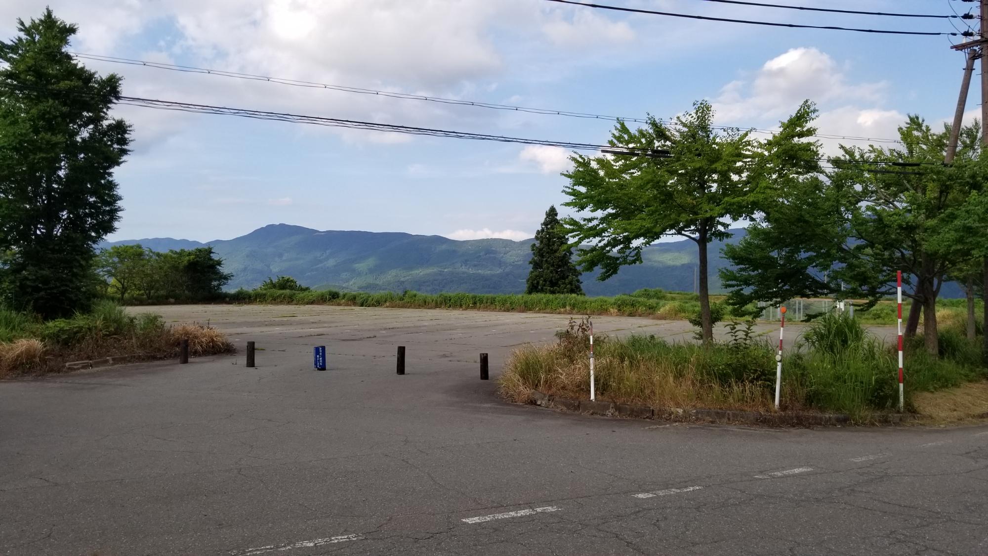 奥に山の見える駐車場の写真